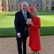 Marie Shevas - supported by husband Ron - received her MBE at Windsor Castle from Princess Anne.