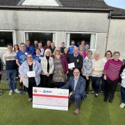 The 4 Winds trustees and representatives of the successful groups at the presentation of grants at Lumphinnans Community Bowling Club.