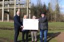 The Save the Cage group receive a cheque from Muir Homes' Business Development Director David Fairweather.