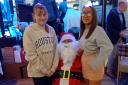 Santa with the two youngest members of the company,