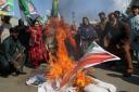 Pakistani protesters burn an effigy of Indian prime minister and representation of Indian flag during a rally in Multan, Pakistan (AP Photo/Asim Tanveer)