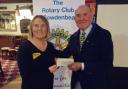Emma Hamilton, of the Dogs Trust, accepts a donation from John Gilfillan, Cowdenbeath Rotary Club president.