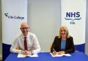 Fife College principal, Jim Metcalfe, and NHS Fife chief executive, Carol Potter, sign the partnership agreement.