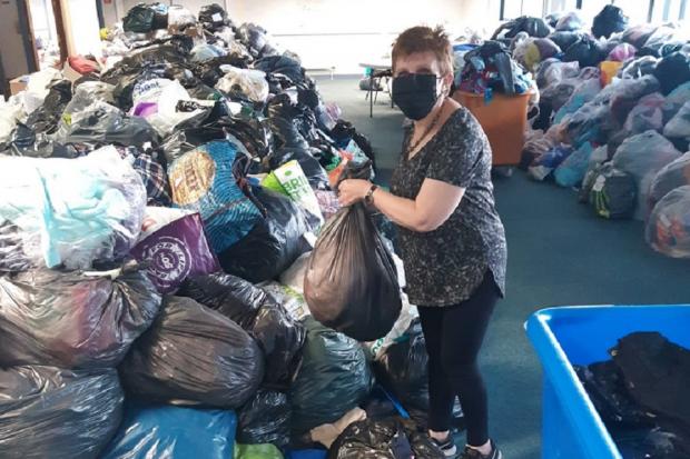 Councillor Judy Hamilton with the bags of donated clothes Fifers have given to refugees.
