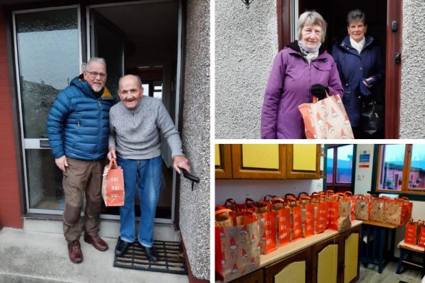 Crossgates senior citizens receive their goody bag from the community council.