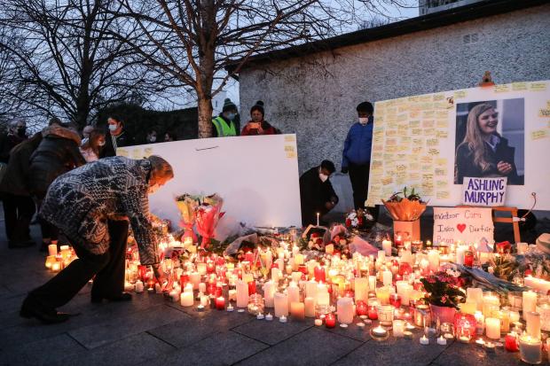 Local people light candles after a vigil in memory of Aisling Murphy