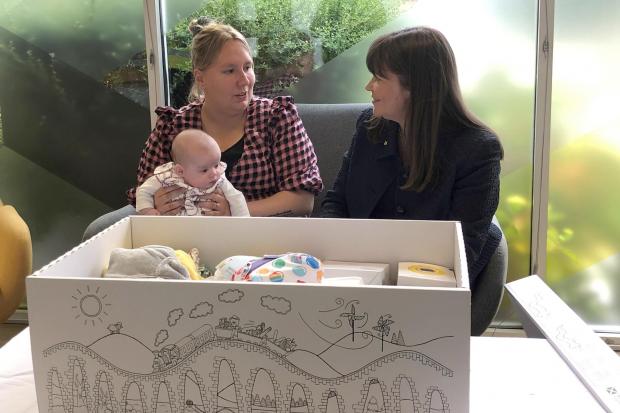 Courtney McLeod and her four-month-old daughter Addison meet Children's minister Clare Haughey at APS (Group) Scotland in Edinburgh