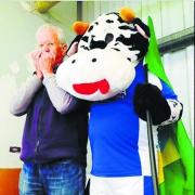 Ron Ferguson with his mouth organ and the Cowdenbeath FC mascot, Bluebell the coo.