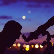 A person stargazing through a telescope. Credit: PA