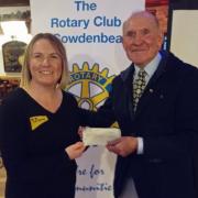 Emma Hamilton, of the Dogs Trust, accepts a donation from John Gilfillan, Cowdenbeath Rotary Club president.