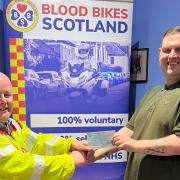 Brother Girvan Easton Right Worshipful Master hands over the donation to Blood Bikes Scotland volunteer Colin Weaver.