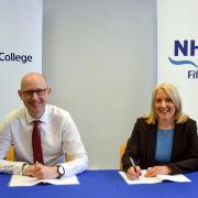 Fife College principal, Jim Metcalfe, and NHS Fife chief executive, Carol Potter, sign the partnership agreement.