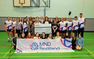 Morna McMurray and Kim Kilgour with the cheque and the adult and some of the junior team. Photo: David Wardle.