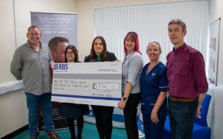 NHS Fife staff receive a cheque from Fife Masonic Lodges.